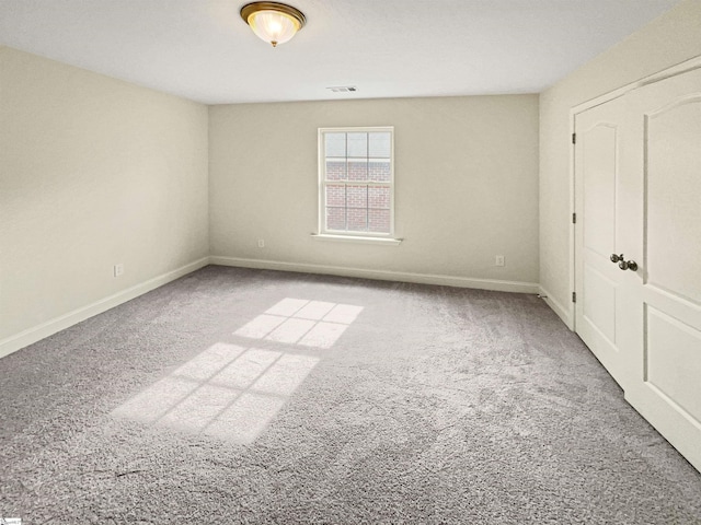 unfurnished room featuring carpet