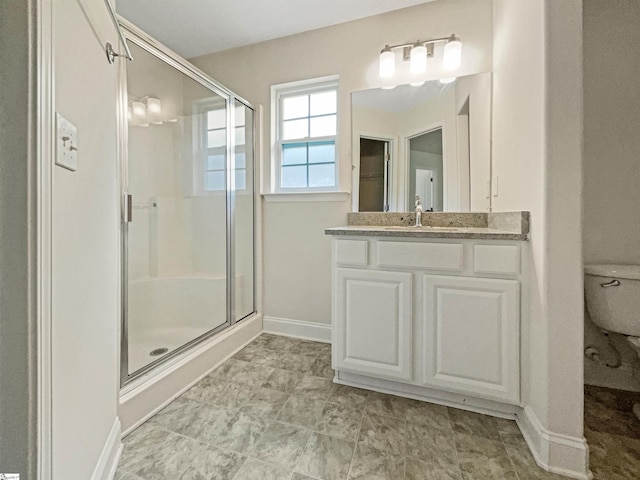 bathroom featuring walk in shower, vanity, and toilet