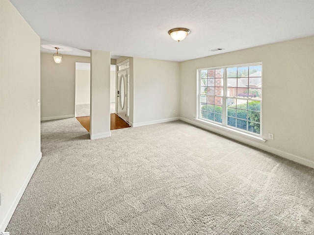 unfurnished room with a textured ceiling and carpet flooring