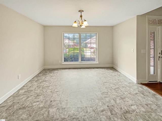 empty room featuring an inviting chandelier