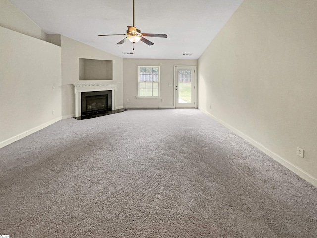 unfurnished living room with carpet flooring, vaulted ceiling, and ceiling fan