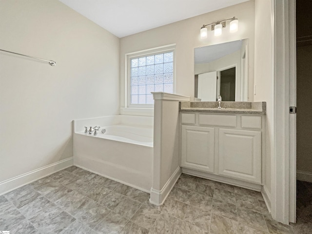 bathroom with vanity and a washtub