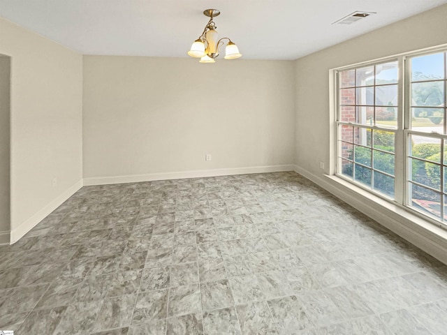 empty room with a chandelier and a wealth of natural light