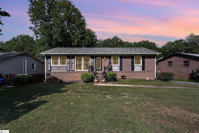 ranch-style house featuring a yard