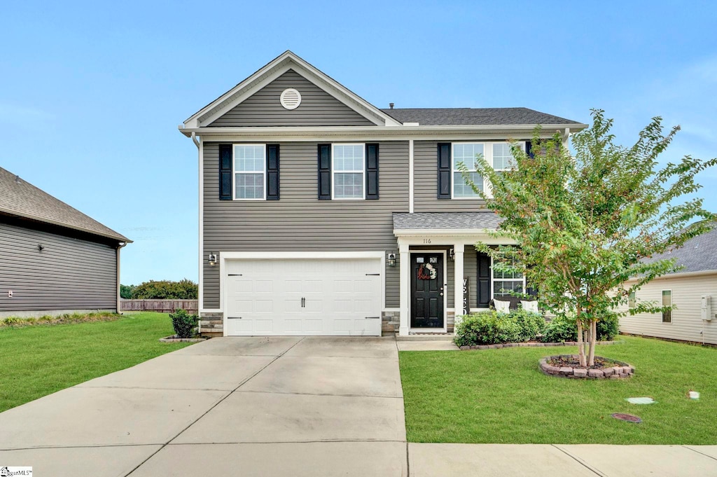 view of front of house featuring a front yard and a garage