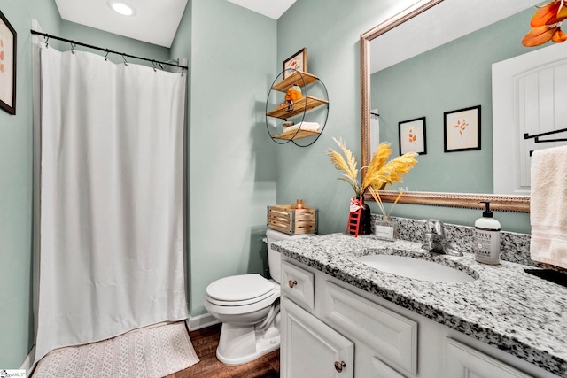 bathroom with a shower with shower curtain, toilet, hardwood / wood-style flooring, and vanity