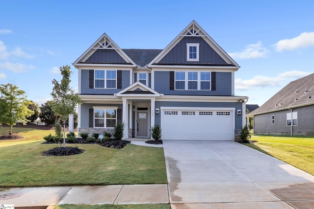 craftsman house with a front yard and a garage