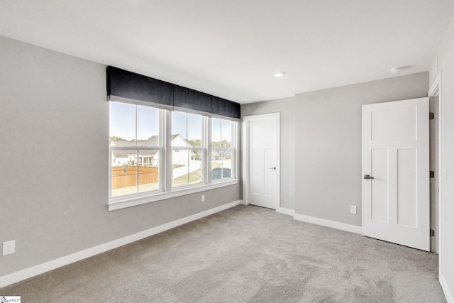 unfurnished room with light colored carpet