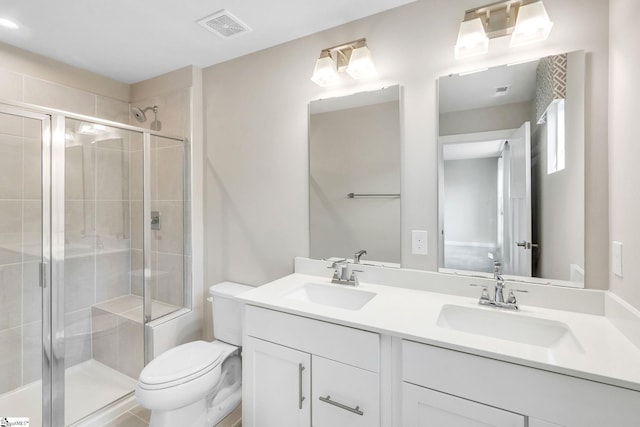 bathroom featuring an enclosed shower, toilet, and vanity