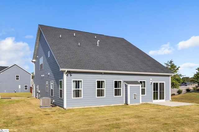 rear view of house featuring a lawn, a patio, and central AC unit