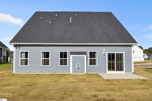 rear view of property featuring a yard and a patio