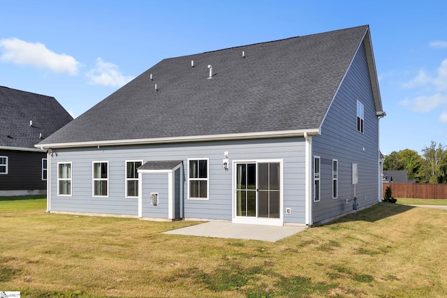 rear view of property featuring a yard and a patio area