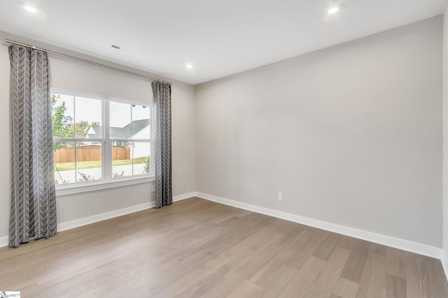 spare room with light hardwood / wood-style floors