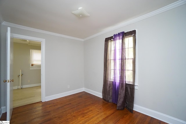 spare room with dark hardwood / wood-style floors and ornamental molding