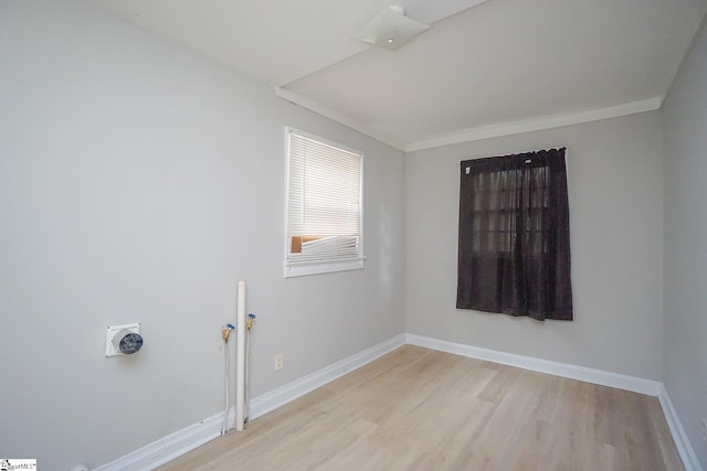 washroom with light hardwood / wood-style floors and ornamental molding