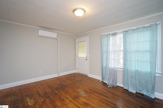 spare room featuring ornamental molding, an AC wall unit, and dark hardwood / wood-style floors