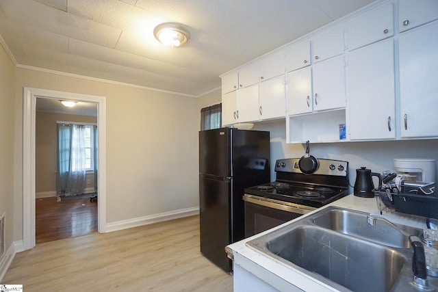 kitchen featuring white cabinets, stainless steel electric range, light hardwood / wood-style floors, and sink