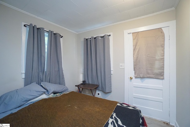 bedroom featuring crown molding and hardwood / wood-style floors