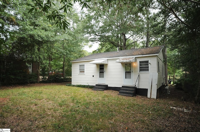 rear view of house with a lawn