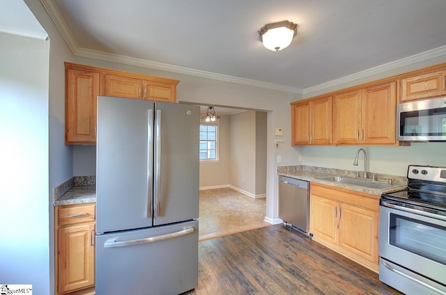 kitchen with appliances with stainless steel finishes, dark hardwood / wood-style floors, sink, and crown molding