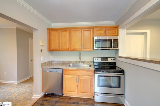 kitchen with ornamental molding, stainless steel appliances, and sink