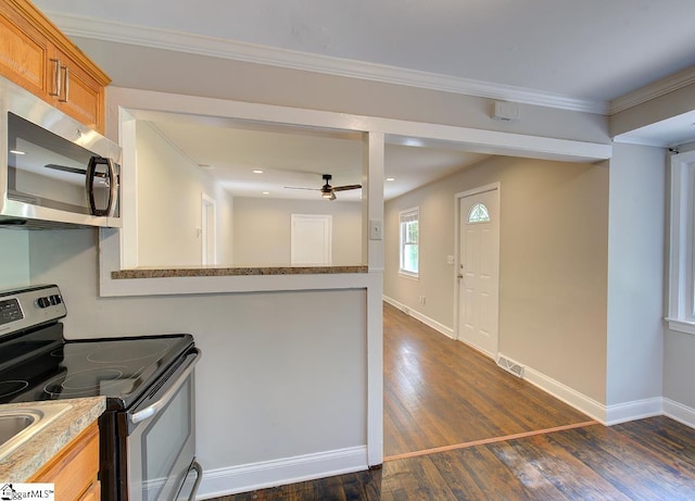 kitchen with light stone countertops, dark hardwood / wood-style flooring, stainless steel appliances, ceiling fan, and ornamental molding