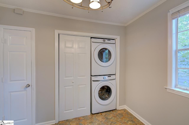 laundry room featuring ornamental molding and stacked washing maching and dryer