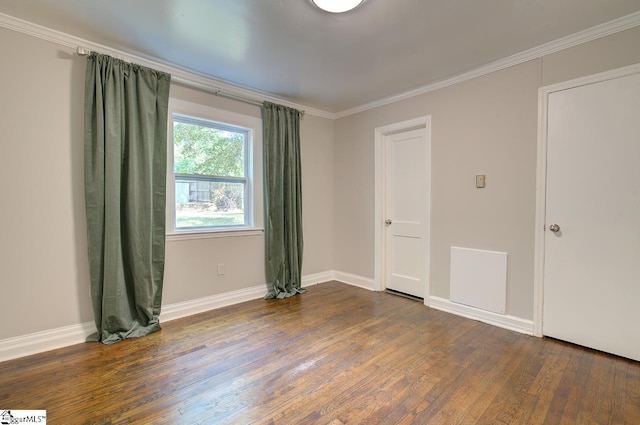 empty room with crown molding and dark hardwood / wood-style flooring