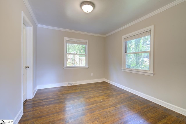 empty room with ornamental molding and dark wood-type flooring