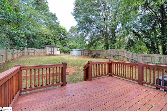 wooden deck with a storage unit and a yard