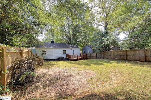 view of yard with a deck and central AC