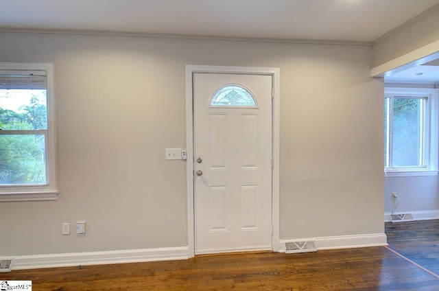 entrance foyer featuring ornamental molding and dark wood-type flooring