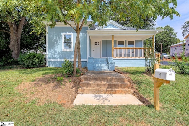 bungalow-style house featuring a front lawn and covered porch