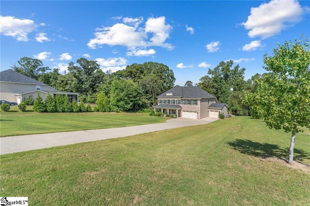 view of front facade featuring a front yard and a garage