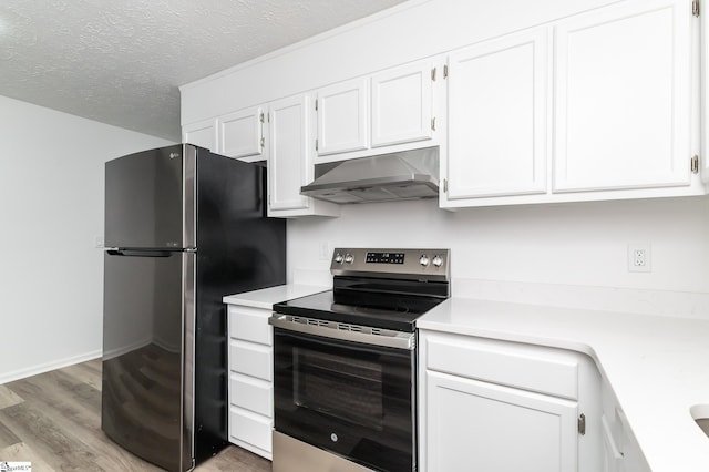 kitchen with light hardwood / wood-style flooring, stainless steel appliances, white cabinets, and a textured ceiling