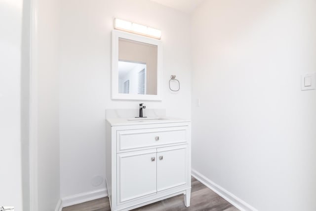 bathroom with vanity and hardwood / wood-style floors