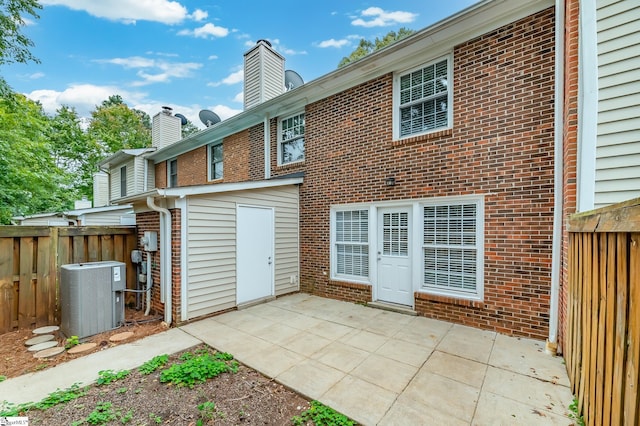 rear view of property with a patio and central AC