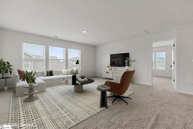 living room with light carpet and a wealth of natural light