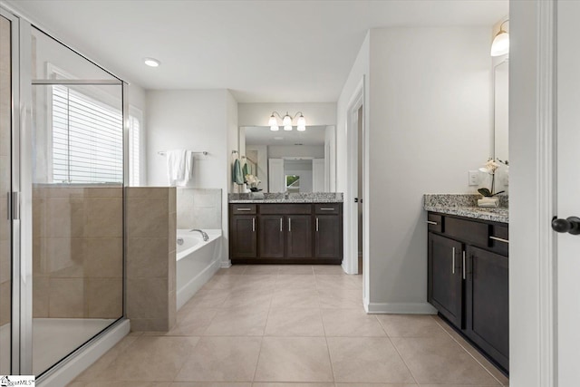 bathroom with vanity, plus walk in shower, and tile patterned flooring