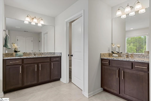 bathroom featuring tile patterned floors, vanity, and toilet