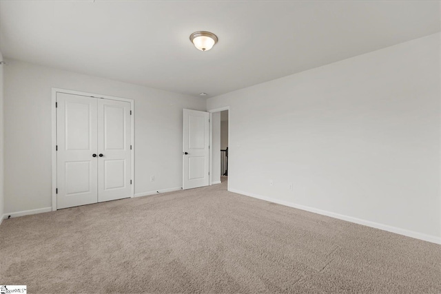 unfurnished bedroom featuring carpet floors and a closet