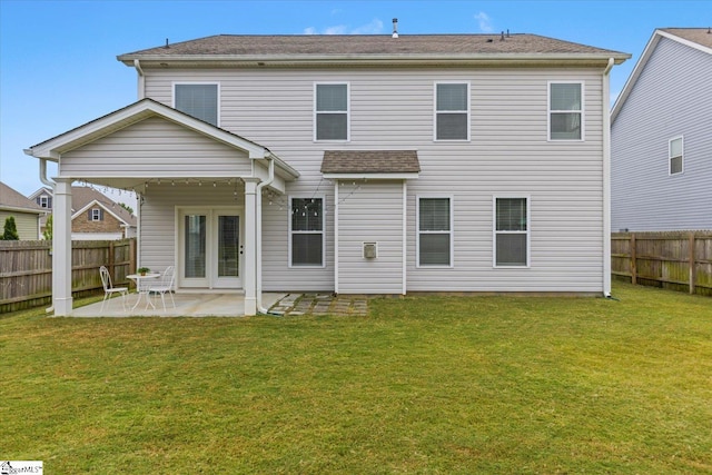 rear view of house featuring a yard and a patio area