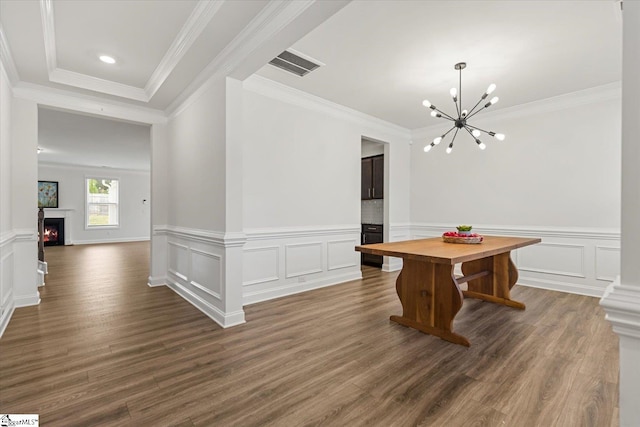 dining room featuring ornamental molding, an inviting chandelier, and dark wood-type flooring