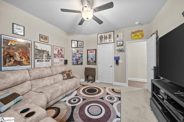 living room with light hardwood / wood-style floors and ceiling fan