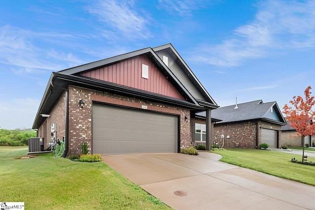 view of front of home with a garage, central AC, and a front yard