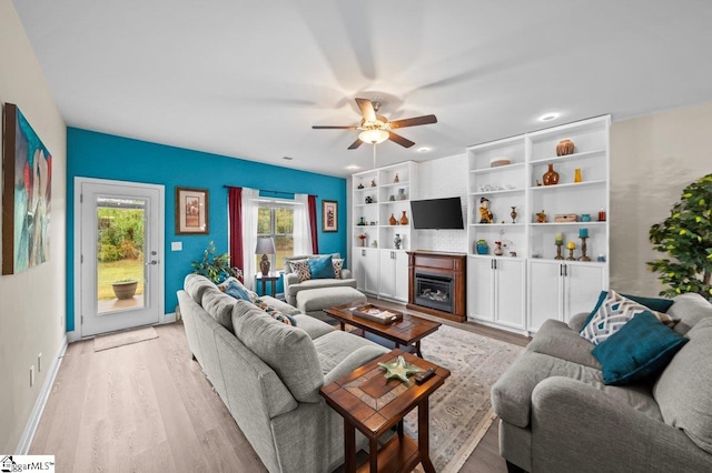 living room featuring light wood-type flooring and ceiling fan