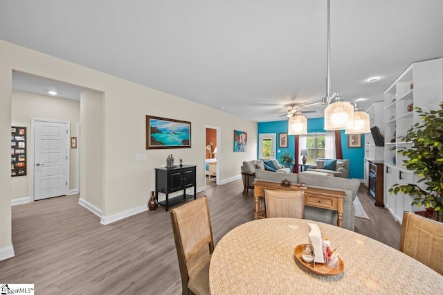 dining room featuring wood-type flooring and ceiling fan