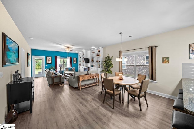 dining room featuring ceiling fan, plenty of natural light, and hardwood / wood-style floors