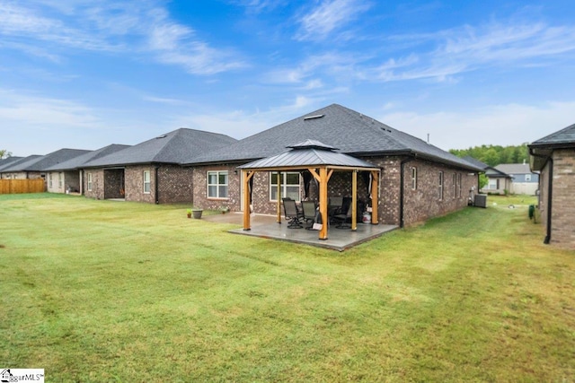 back of property with a lawn, a patio, a gazebo, and cooling unit