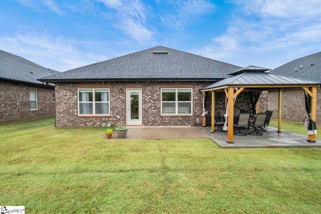 rear view of property with a lawn, a gazebo, and a patio area